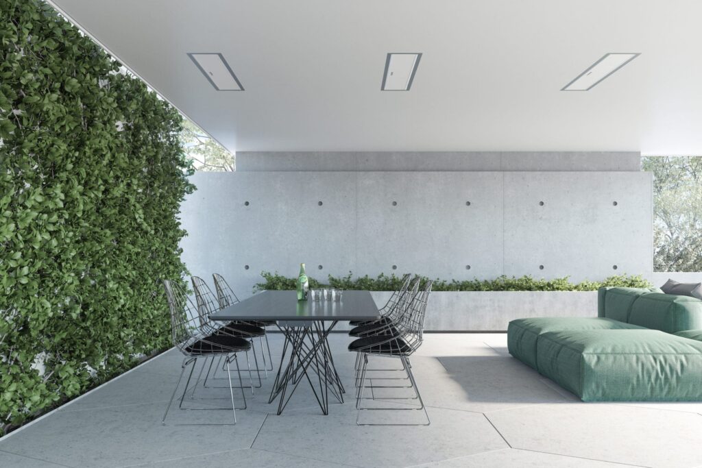 Bright outdoor entertaining area with modern grey table and electric heaters