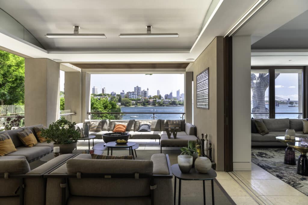 Outdoor lounge area overlooking Sydney skyline and harbour with electric heaters